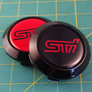 Red STI Logo on black background on black cap
